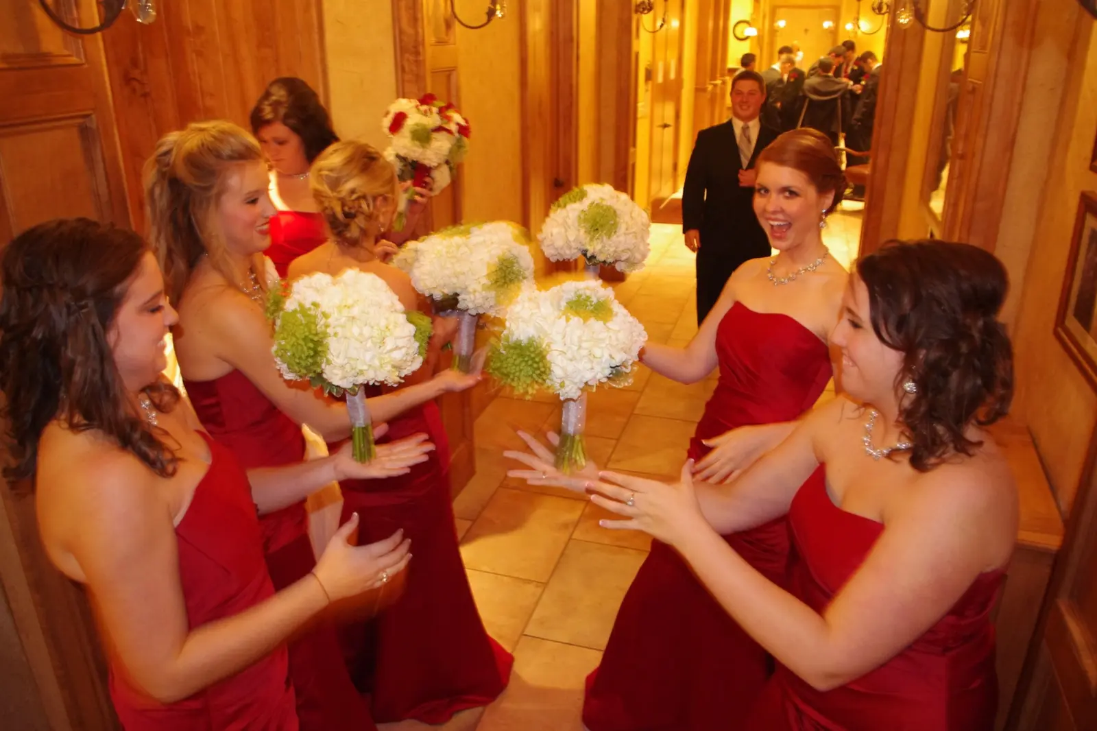 A bride laughing with her bridesmaids