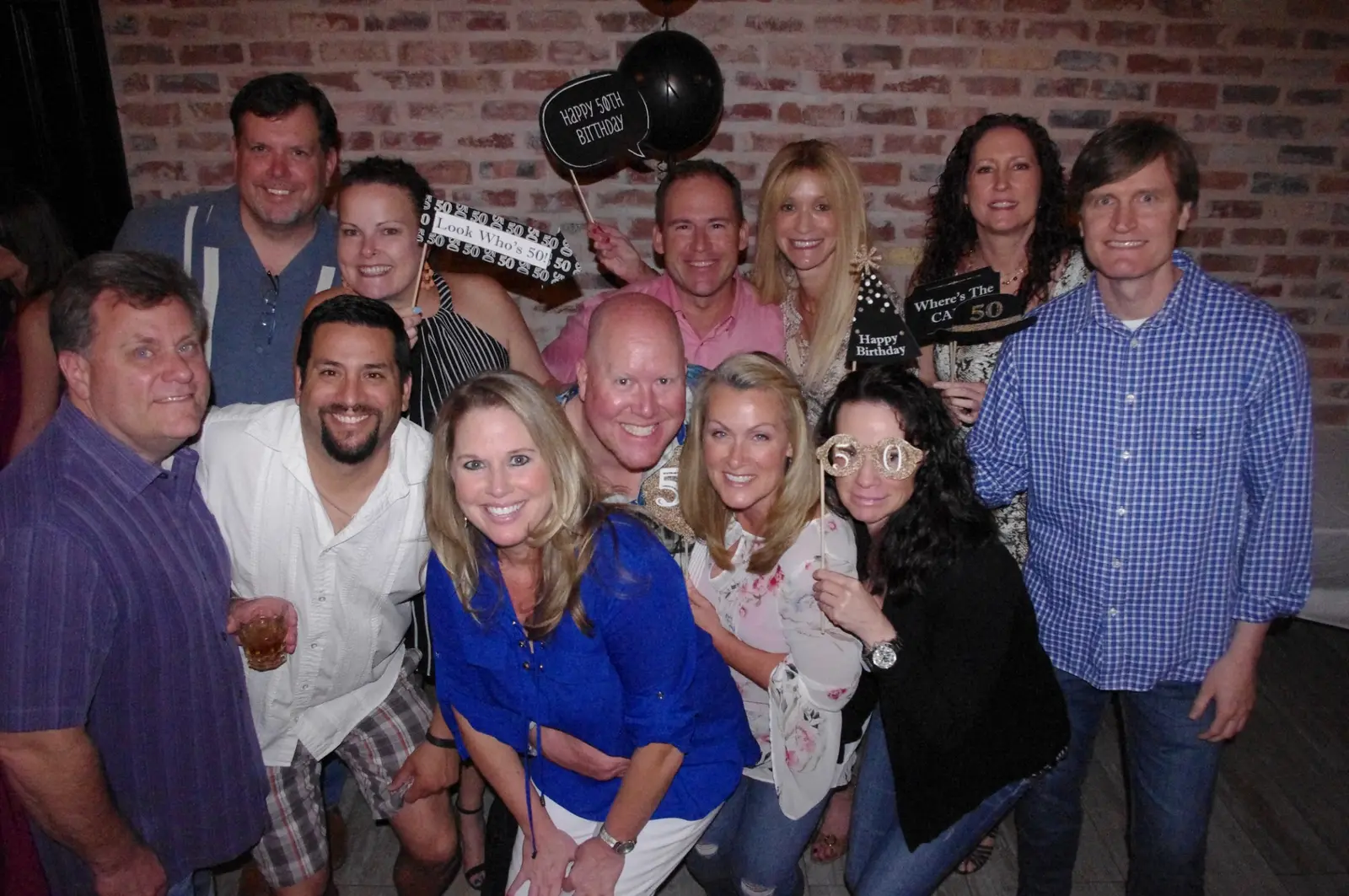 Friends gathered together and smiling at a celebration